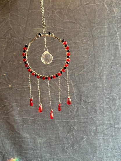 Silver hoop wire wrapped with onyx and red glass beads