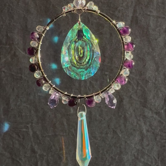 amethyst crystal suncatcher spinning with rainbows