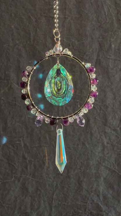 amethyst crystal suncatcher spinning with rainbows